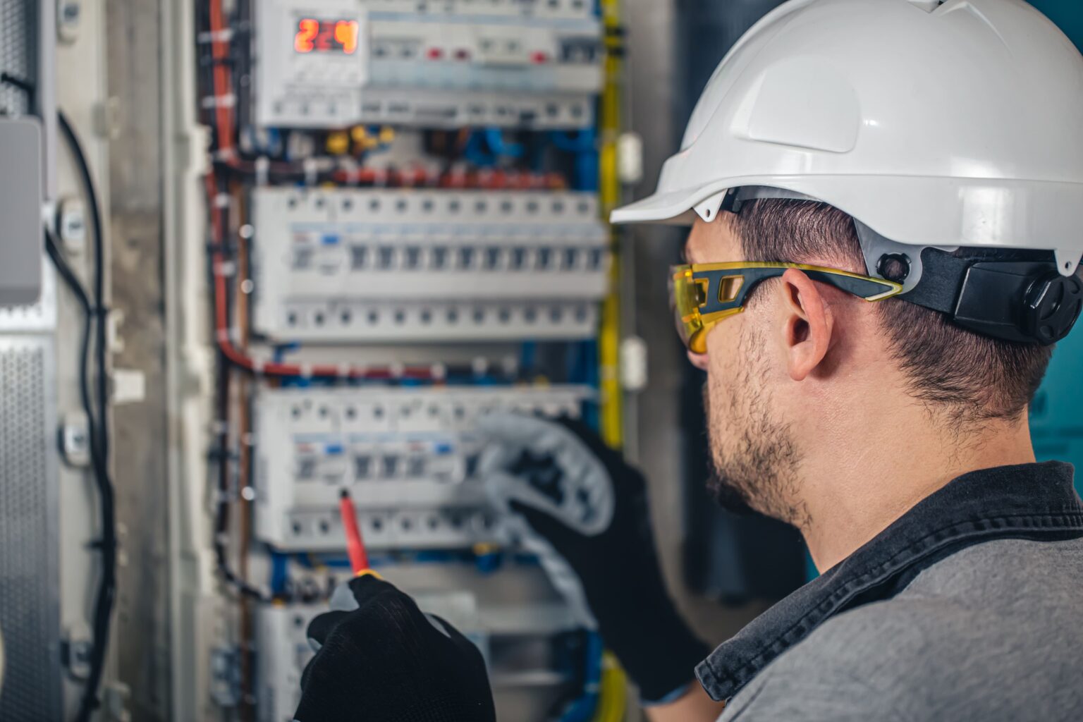 man-electrical-technician-working-switchboard-with-fuses